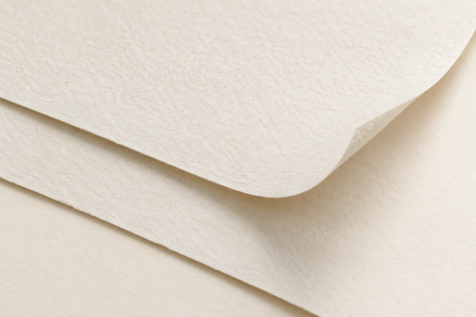 Illustrative close-up concept of warm natural paper with a refined fibre texture.
